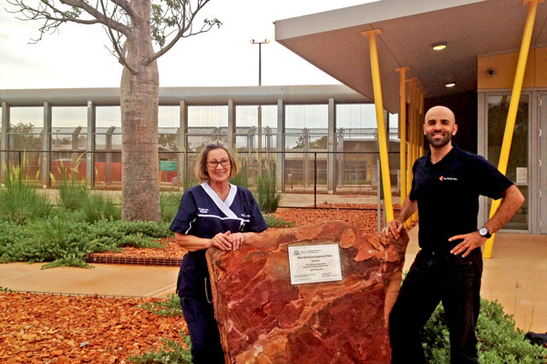 Hessom and a female nurse standing outside a gaol in remote WA.